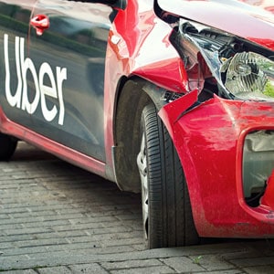 Damaged Uber car involved in an accident, highlighting the importance of filing a claim with Uber or Lyft