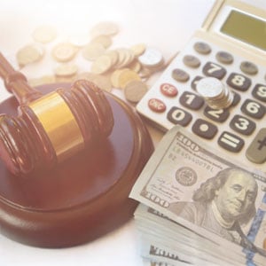 Gavel, money, and calculator—understanding recoverable damages in California lawsuits.